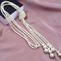 Gorgeous pearl sweater necklace that is sure to please. This necklace can be worn with virtually any outfit (even turtleneck sweaters) for a bold but classy touch. Includes free earrings. Total length is 49". Elegant White Pearl Chain Long Necklace, Elegant Pearl Long Necklace As Gift, Elegant Pearl Long Necklace For Gift, Elegant White Long Chain Necklace, Pearl White Long Pearl Necklace In Elegant Style, Elegant Pearl White Long Pearl Necklace, Elegant Pearl White Long Necklace, Long Pearl White Pearl Necklace For Party, Elegant Long Beaded Necklace