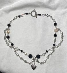 handmade by me :) made with various glass beads, glass pearls, empty heart locket, and a sturdy stainless steel toggle clasp  the necklace measures 15.5  inches   treat gently as costume jewelry  let me know if you have any questions Black Handmade Necklace, Emo Beaded Necklace, Grunge Jewelry Necklaces, Grunge Beaded Necklace, Fairy Core Necklace, Black Beads Necklace, Grunge Chokers, Necklace Grunge, Black And White Jewelry