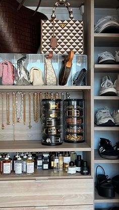 an organized closet with lots of items on the shelves and in bins for purses