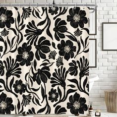 a black and white shower curtain with flowers on it