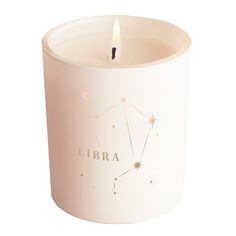 a lit candle with the word libra written on it