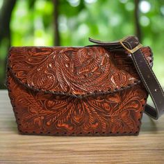 Featuring a gorgeous chiseled artisan design, this rustic  HAND TOOLED LEATHER Purse will help you bring a little VINTAGE flair to your everyday outfit. The perfect size for fitting all of your everyday essentials, this purse was actually handmade with love and care by talented artisans giving it a rustic touch that's hard to find in stores.  This purse comes CHISELED BOTH SIDES. Crafted from GENUINE COWHIDE LEATHER and best for casual and everyday wear, you'll love how this leather  bag matches Leather Bag For Women, Tooled Leather Bag, Leather Making, Tooled Leather Purse, Bohemian Bags, Hand Tooled Leather, Leather Bags Handmade, Artisan Design, Leather Pieces