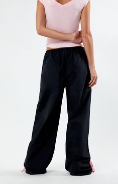 Step into athleisure vibes with the PacSun Black Wide Leg Track Pants. These trendy track pants combine comfort and style with a wide-leg silhouette, stripes down the leg, and ties at the ankles, offering a versatile and laid-back addition to your wardrobe, perfect for casual outings or cozy days at home.


	11.5" rise
	31.5" inseam
	23" leg opening
	High-rise
	Elastic waistband
	Stripes down the legs
	Tie detail at the ankle
	Side hand pockets
	Wide leg opening
	Relaxed fit
	Room Wide Leg Track Pants, Track Pants Women, Indie Brands, Pant Shirt, Skirted Swimwear, Short Rompers, Dress Romper, Basic Tees, Hoodie Dress