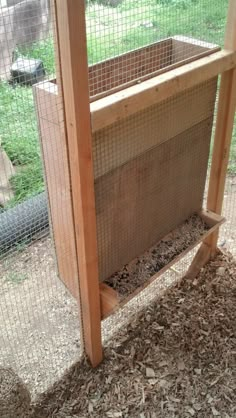 a chicken coop with wood and wire around it