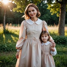 a woman and her daughter are standing in the grass with their arms around each other