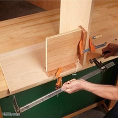 a man is working on a piece of wood