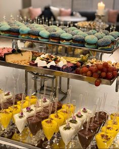 desserts and pastries are displayed on trays