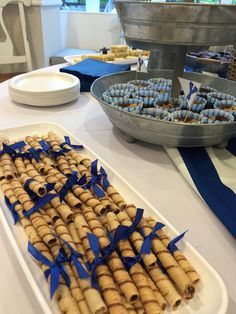 an assortment of food on a table with blue ribbon around the edges and plates in the background