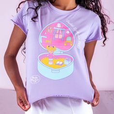 Show off your love for the pocket sized cutie with this adorable Polly Pocket™ Crop T-Shirt. This t-shirt comes in the most perfect shade of pastel purple and features a large graphic, front and center, of Polly Pocket in a heart-shaped compact. Made with the perfect amount of 90s style, this cropped tee features ruffled edges, giving it a playful and nostalgic vibe that pairs great with low rise jeans or a cute frilly skirt. This tee is complete with the fun phrase “Pocket Sized since 1989”. Cr Frilly Skirt, 90s Vibes, Crop T Shirt, Polly Pocket, 90s Style, Cropped Tee, Pastel Purple, Low Rise Jeans, Pocket Tshirt