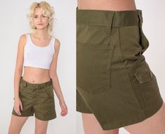 Vintage 70s Boy Scout shorts in olive green with patch pockets and a high waist. Please see measurements and condition below. Every garment we sell is authentic vintage! You will receive the exact item photographed. Condition: Very good vintage with light general wear. Best fits women's: Small. Boy's cut, so slim in the hip compared to the waist. Tag: ILGWU Material:  Feels like Cotton MEASUREMENTS Taken from seam to seam while the garment is lying flat. Double the armpit, waist, and hips For re Green Military Style Short Length Shorts, Vintage Cotton Cargo Shorts For Summer, Vintage Cotton Khaki Shorts, Military Style Green Shorts, Green Military Style Shorts, High-waisted Green Cargo Shorts, Green High-waisted Cargo Shorts, Vintage Bottoms With Side Pockets, Short Length, Retro Khaki Bottoms With Pockets