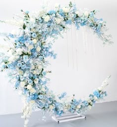 a white and blue floral wreath on a wall