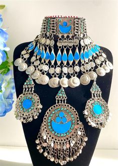 Afghan light blue vintage 3 piece jewellery set, Afghan jewellery  Set includes: -1 pair of earrings  -1 chocker necklace  -1 tikka  Message for any enquiries Our Aim as a business is to connect Afghan women with their roots and to make anyone that purchases our jewellery feel powerful and beautiful as each and everyone of our items is handcrafted with care and love. Blue Metal Jewelry For Festivals, Vintage Blue Choker Jewelry, Unique Blue Jewelry For Festivals, Vintage Light Blue Handmade Jewelry, Bohemian Light Blue Jewelry For Festivals, Blue Handmade Vintage Choker, Vintage Blue Handmade Choker, Blue Vintage Necklace For Festival, Vintage Light Blue Jewelry For Wedding