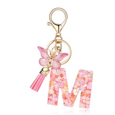 the letter m is decorated with pink flowers and a butterfly on it's side