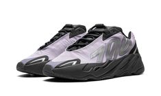 The adidas Yeezy Boost 700 MNVN “Geode” is a December 2021 release of the popular “dad shoe” by Kanye West that surprise-released on West’s Yeezy Supply website.  It features silver reflective “700” branding on the middle of the lightweight nylon upper.  Contrasting reflective accenting on the forefoot and heel provide a tech-inspired look.  The blacked-out midsole contains Boost foam technology for soft, responsive cushioning.  Release date: December 20, 2021 Yeezy 700 Mnvn, Adidas Campus 80s, Dad Shoe, Adidas Yeezy 700, Nike X Travis Scott, Converse Run Star Hike, Low Air Jordan 1, Yeezy 700, Adidas Spezial