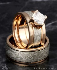 two gold wedding rings with a princess cut diamond