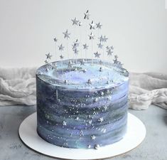 a blue cake with silver stars on top