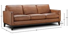 a brown leather couch sitting on top of a white floor next to a wooden frame