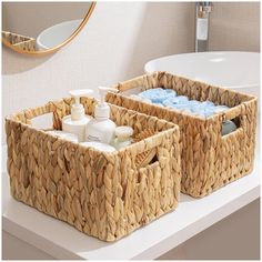 two wicker baskets sitting on top of a bathroom counter