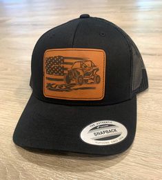 Display you KRX SXS Pride 🇺🇸 with this beautiful hat!  Yupoong Snapback Truck Driver Hat. Adjustable snapback so one size fits most. Our 3.5"x2.5" leather patches are made by us in Michigan, USA. We take pride in every hat we ship. Thanks for shopping!  Hat care: Patch hats are not to be washed, the best way to clean is with a mild detergent and allow to air dry. Leather patch is a strong & durable patch, it is applied through a heat activated adhesive, not sew Please select hat variation at checkout! Custom Flat Bill Hat For Outdoor, Custom Outdoor Hat With Flat Bill, Adjustable Black Hats With Patches, Adjustable Black Hat With Patches, Black Adjustable Hat With Patches, Black Hat With Leather Patch, One Size Fits Most, Black Hat With Leather Patch And Flat Brim, Black Hat With Leather Patch One Size, Black Hats With Leather Patch