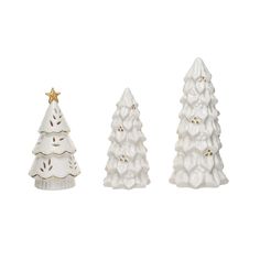 three white ceramic christmas trees on a white background