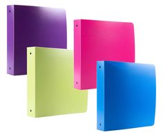 three different colored binders sitting next to each other