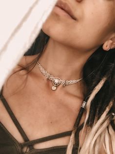 a close up of a person wearing a necklace