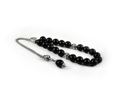 Handcrafted Greek Komboloi - Worry Beads created from silver tone metal chain of 20 black onyx Beads, 2 metal round beads and triangle shape metal Master Bead. A pocket sized set of greek worry beads which can be used for passing time and relaxation. It would also make a beautiful gift. Features: Item Length: 23cm / 9 inches Beads Size: 10mm / 0.40 inches Beads Material: Black onyx beads Metal Materials: Silver tone alloy Here you can browse more items in our shop: https://www.etsy.com/shop/sunn Elegant Black Beads, Gems, And Cabochons For Gifts, Black Beaded Chain Beads As Gift, Black Beaded Chain As A Gift, Black Beaded Chain For Gift, Spiritual Black Beads With Silver Accents, Silver Beaded Chain With Round Beads, Silver Onyx Beaded Bracelets With 8mm Beads, Silver Onyx Beaded Bracelets For Gift, Silver Onyx Beaded Bracelets As Gift