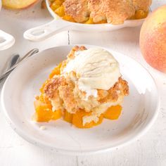 a piece of pie sitting on top of a white plate next to some peaches