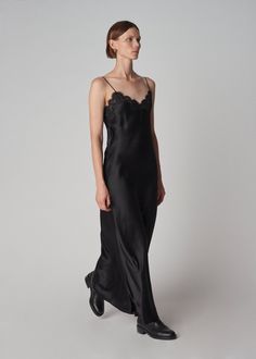 Long slip dress in 16mm opaque biascut silk satin glides gracefully against the skin. French lace trims the neckline. Adjustable spaghetti straps and cleverly positioned encased elasticized back ensure proper fit. French seam, baby hem. Details 100% Silk Trim: 50% Cotton 30% Viscose 20% Polyamide 4704CSSC-CORE Black True to size. See size guide. Approx 47" in total length. Model is 5'9" 30" bust and wears a size Small. Black Velvet Slip Dress, Long Slip Dress, Long Slip, Black Slip Dress, Lace Slip Dress, Lace Trims, Lace Slip, French Seam, Satin Slip