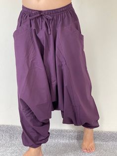 "Harem Pants Ethically Made in Thailand, Low crotch yoga pant, Unisex harem pants, Gorgeous Harem Pants, Lounge & Yoga Trousers Thai Cotton harem pants have the \"flow\", perfect for yoga or just a cool strolling. Comfort and character are what these pants are all about. They have the traditional sarong look & feel but a lot more practical when it comes to activities like yoga. As a bonus, they are convertible! Just pull them up and you get yourself a cute jumpsuit in a flash. Together w Yoga Harem Pants With Drop Crotch, Yoga Harem Pants With Drop Crotch And Relaxed Fit, Yoga Harem Pants With Pockets, Relaxed Fit Harem Yoga Pants, Relaxed Fit Drop Crotch Harem Pants For Yoga, Stretch Solid Color Harem Yoga Pants, Stretch Harem Yoga Pants, Stretch Harem Pants With Pockets For Festival, Baggy Full-length Harem Pants For Yoga