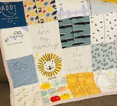 a baby's quilt is on the couch with its handwritten name and pictures