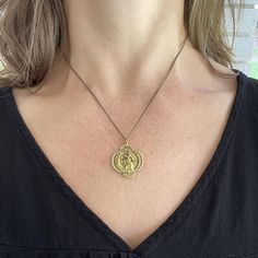 Travelers Necklace – Ornamental Things Yellow Gold Brass Medallion Charm Necklace, Brass Medallion Charm Necklaces, Brass Charm Necklace With Large Round Pendant, Spiritual Brass Coin Necklace With Round Pendant, Symbolic Brass Medallion Coin Necklace, Symbolic Brass Coin Necklace With Round Pendant, Spiritual Brass Charm Necklace With Coin Pendant, Engraved Medallion Brass Charm Necklaces, Brass Amulet Locket Coin Necklace