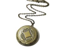 "Visit our full collection of vintage treasures at www.upcycledworks.com This Locket necklace is on a brass chain and measures 28\" in length. The locket measures 1 3/4\" round. It opens for your favorite photograph. Picture size for this locket is 1 1/4\" round. You will have to find a photo that fits and glue it into place. Sorry we do not engrave at this time. The perfect gift for all ages! H O W * T O * O R D E R: 1. Select options from the dropdown menu 2. Add to cart and proceed to checkou Brass Medallion Locket Necklace With Adjustable Chain, Adjustable Round Locket Pendant Necklace, Vintage Medallion Locket Necklace For Gift, Vintage Antique Gold Medallion Necklace Gift, Vintage Antique Gold Medallion Necklace As Gift, Antique Gold Vintage Medallion Necklace As Gift, Bohemian Engraved Round Locket Necklace, Adjustable Vintage Charm Locket Necklace With Round Pendant, Adjustable Antique Locket Necklace With Round Pendant