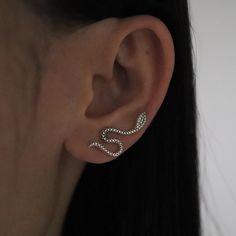 Embrace the allure of the mystical with our Silver Oxidized Snake Ear Climber. Expertly crafted from high-quality sterling silver, this striking piece of jewelry is designed to make a bold statement. The ear climber features a sinuous snake, meticulously detailed with scales and a gracefully curved body that climbs up the ear, creating an eye-catching and unique accessory. The oxidized finish adds depth and contrast to the intricate design, enhancing the lifelike appearance of the snake. * Desig Snake Earrings Silver, Snake-shaped Pierced Earrings For Gift, Silver Snake-shaped Party Earrings, Elegant Silver Snake-shaped Earrings, Silver Snake-shaped Single Earring, Snake Gift, Baby Snakes, Earrings Snake, Snake Ears