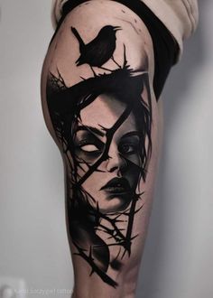 a woman's leg with black and white tattoos on it, including a bird perched on her head