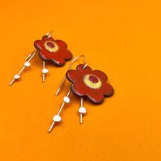 BIG BOLD FLAME ORANGE BLOSSOM earrings.... statement earrings for dressing up with just a bit of swing.  Wear what you love! Handmade enamel floral earrings perfect as a birthday or anniversay gift. handmade earrings... sawn, soldered, sanded,  and enameled... ..handfabricated and colored with ground frit these enamel earrings measure aproximately 2" long by 7/8".  * NOTE: The earring's enamel surface has tiny flecks of other colors embedded. The earrings are handmade and no two earrings are perfectly alike.  ♦ actually handmade ;) ♦ ready to ship ♦ measure approximately 2" long by 7/8" wide ♦ packaged in a gift box ...the perfect gift for someone special... or yourself.  #metalobjects - brandishing a torch and hammer for fun! Red Flower-shaped Earrings For Spring, Red Flower Charm Jewelry For Spring, Red Spring Jewelry With Flower Charm, Handmade Red Earrings For Spring, Whimsical Spring Flower Earrings With Ear Wire, Red Flower Shaped Earrings For Spring, Spring Red Jewelry With Flower Charm, Red Jewelry With Flower Charm For Spring, Red Spring Earrings