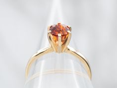 This ring has got it all! An eye-catching solitaire of hessonite garnet, nestled in a gleaming yellow gold setting. The perfect touch of classiness and chic for your ring collection. Who's ready to spin some heads?Metal: 14K Yellow GoldGem: Hessonite Garnet 1.18 CaratsGem Measurements: 5.9 mm, RoundRing Size: 6.50Marks: "14K" Stamped on the inside band Opal Solitaire Ring, Sapphire Solitaire Ring, Sapphire Solitaire, Hessonite Garnet, Ring Collection, Yellow Gold Setting, Green Sapphire, Champagne Diamond, Blue Zircon