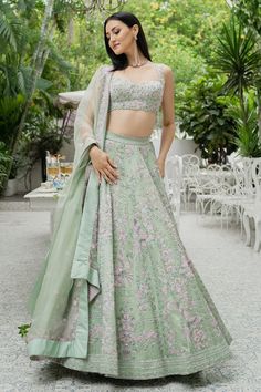 Pistachio green lehenga with bead embellishment in floral motifs and cutwork detail on the waistband. Comes with sleeveless blouse and dupatta.
Components:3
Pattern:Embellishment
Type of Work:Bugle Beads, Cutdana and Sequin
Neckline:Sweetheart
Sleeve Length:Sleeveless
Fabric:Silk Organza
Color:Green
Other Details:
Blouse with cutwork detail
Dupatta with embroidered border
Tie up on the side
Occasion:Wedding - Aza Fashions Fitted Green Gown With Floral Embroidery, Green Lehenga With Intricate Embroidery For Reception, Embroidered Pista Green Sets For Reception, Green Gown With Intricate Embroidery For Reception, Green Embroidered Gown For Reception, Sleeveless Green Wedding Gown, Green Bollywood Lehenga With Floral Embroidery, Bollywood Style Green Lehenga With Floral Embroidery, Green Resham Embroidered Fabric For Reception