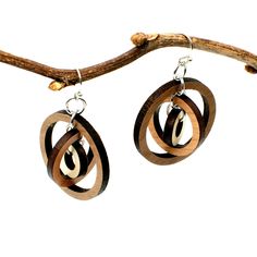 "These gyroscope circle earrings appear simple but possess constantly changing visual intrigue. Three concentric circles encompass one another, creating multiple facets with continual movement and interest. Three tones of wood - walnut, cherry, and maple - add further texture and detail. Laser cut wood earrings can be dressed up or down, making them the perfect complement to any outfit! These earrings are strong but so lightweight and comfortable, you will hardly know you have them on! Pair with Modern Small Hoop Brown Earrings, Modern Brown Small Hoop Earrings, Modern Brown Round Jewelry, Modern Hypoallergenic Round Wrap Earrings, Inspirational Keychains, Laser Cut Wood Earrings, Laser Cut Earrings, Concentric Circles, Cut Earrings