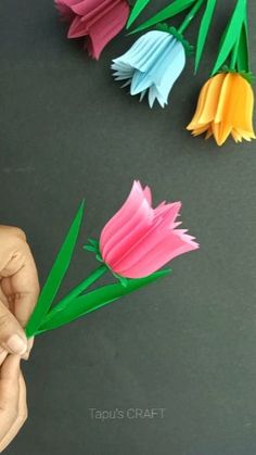 someone is making paper flowers out of construction paper