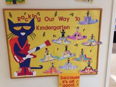 a bulletin board with pictures of cats and musical instruments on it, along with a sign that says rockin'our way to kindergarten because it's all good