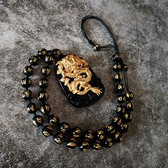 Unleash the Fury of the Dragon! Kings of the spirit world, dragons fear nothing. In Eastern culture, the Yellow Dragon 黃龍 is the fifth element of Earth and the God at the center of the Cosmos This Gold Dragon Necklace features:☯ 18K Carved Gold Dragon ☯ Black Onyx Beaded Necklace ☯ Black Onyx Pendant Are you ready to release the dragon? Luxury Gold Necklaces With Dragon Design, Luxury Yellow Gold Necklace With Dragon Design, God At The Center, Japanese Accessories, Fear Nothing, Beaded Necklace Black, Dragon Chino, The Fifth Element, Dragon Black