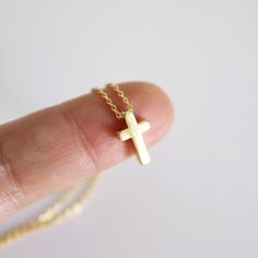 "A beautiful and lovely tiny gold necklace featuring a small & cute gold cross pendant.Lobster clasp closure. Simple and warm.  The dainty gold cross necklace is perfectly paired with any outfit or a great gift! Your beautiful necklace will ship in a gift box. If you have any questions, please feel free to contact me. Thanks :)    ♥ Chain length 14\"-18\" ♥ Cross pendant  1/4\" x 3/8\" ♥ Gold plated over brass ♥ Delivery Time Fast shipping within 1 - 3 days  + See more Rudiana Accessories + www.Rudiana.etsy.com" Gold Cross Necklace In 14k Gold Filled, Simple Tiny Gold Charm Necklace, Gold Cross Charm Necklaces In 14k Gold Filled, 14k Gold Filled Cross Charm Necklace For Gift, 14k Gold Filled Cross Charm Necklace As Gift, Yellow Gold Cross Charm Necklace With Delicate Chain, Minimalist Yellow Gold Cross Necklace With Clavicle Chain, Delicate Yellow Gold Cross Charm Necklace, Gold Cross Necklace With Delicate Chain For Everyday