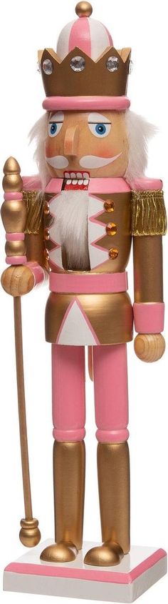 a wooden nutcracker with a pink outfit and gold crown holding a cane in his hand