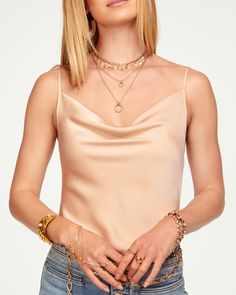 Calling all cami lovers - Abigail was made for you. Frame your figure in this classic top, crafted in the best of satin charmeuse in a rainbow of colors sure to spark joy. Pair with your favorite high waisted denim and a statement necklace and watch this elevated classic take center stage. Size & Fit – This style runs small, we suggest sizing up. – Model is Wearing Size XS– Model is 5'9" Size Guide Details & Care – Dry Clean or Hand Wash– Style #: A0221116 Free Delivery & Easy Returns We offer f Elegant Fitted Gold Camisole, Elegant Gold Camisole, Elegant Gold Sleeveless Camisole, Elegant Gold Camisole For Party, Chic Gold Camisole Tank Top, Gold Tank Top For Evening, Elegant Gold Camisole For Spring, Elegant Gold Tank Top For Evening, Elegant Gold Tank Top