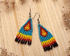 Small Native American inspired Seed Beaded Fringe Earrings - the perfect accessory to add a touch of tradition and culture to any outfit! Crafted from high-quality materials, these beautiful earrings feature intricate beadwork in a traditional Native American design. The fringe is hand-sewn onto a sturdy backing, ensuring that it will hold up well to daily wear. The earrings are designed to be versatile and easy to wear. They are lightweight and comfortable, making them perfect for all-day wear. Southwestern Beaded Earrings With Tassels For Festival, Southwestern Beaded Fringe Earrings As Gift, Southwestern Fringe Beaded Earrings As Gift, Southwestern Fringe Beaded Earrings For Gift, Southwestern Style Beaded Fringe Earrings For Gift, Traditional Fringe Beaded Earrings With Round Beads, Traditional Beaded Earrings With Tassels, Traditional Beaded Earrings With Fringe And Round Beads, Traditional Fringed Beaded Earrings