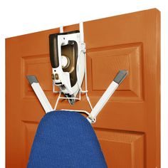 an ironing board mounted to the side of a garage door, with a blue chair underneath it