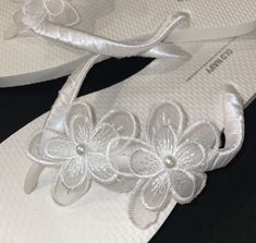 Beautiful Floral Beach Wedding Flip Flops, wrapped in white satin ribbon and decorated with white pearl lace flowers. All flip flops are handmade with a production time of one week plus shipping transit time. Please message me if you would like a specific color ribbon or trim. I would be happy to create sandals that fit your individual wedding needs. Beach Wedding Flip Flops, Bridal Flip Flops, Beach Wedding Sandals, Wedding Flip Flops, Beach Wedding Shoes, Flip Flops Beach, Pearl Flowers, Pearl Lace, Flower Sandals