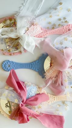 three baby headbands with personalized bows on them, one is pink and the other is blue