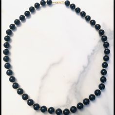 Very Chic And Simple, This Round Black Necklace Has Gold Beads In Between Each Of The Large Shiny Black Beads. It’s Simple And Elegant. Classic Black Round Beaded Jewelry, Black Single Strand Beaded Necklaces For Party, Black Single Strand Beaded Necklace For Party, Party Black Single Strand Beaded Necklace, Classic Onyx Beaded Necklace With Black Beads, Classic Black Beaded Necklaces, Classic Beaded Necklace With Large Beads, Beaded Black Pearl Necklace For Party, Black Beaded Pearl Necklace For Party